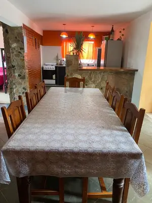 a dining room with a large table and chairs at alquiler temporario en Mina Clavero in Mina Clavero