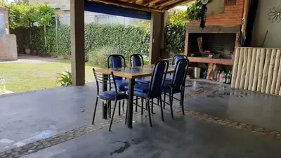 a wooden table and chairs on a patio at alquiler temporario en Mina Clavero in Mina Clavero
