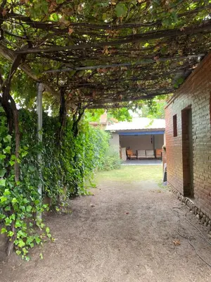 an archway over a yard with a brick building at alquiler temporario en Mina Clavero in Mina Clavero