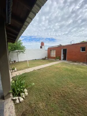 a house with a yard and a building at alquiler temporario en Mina Clavero in Mina Clavero
