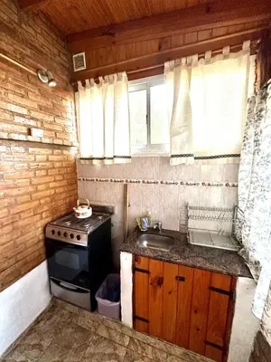 a small kitchen with a stove and a sink at Auken Penkoken in Merlo