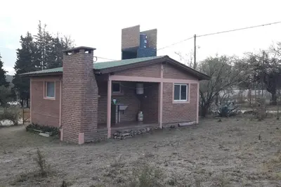 a small brick house with a chimney on top at Casa con gran jardín a 100 mts del Río Amboy in Villa Amancay