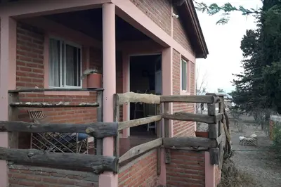 a wooden fence on the side of a house at Casa con gran jardín a 100 mts del Río Amboy in Villa Amancay
