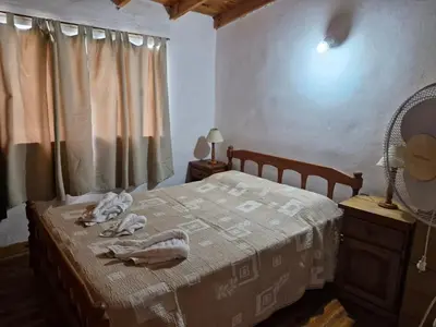 a bedroom with a bed with towels on it at Lo de Juan in Villa General Belgrano