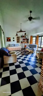 a living room with a checkered floor at Casa de campo EL LULI in La Bolsa