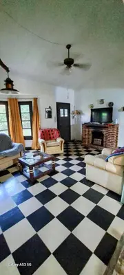 a living room with a black and white checkered floor at Casa de campo EL LULI in La Bolsa