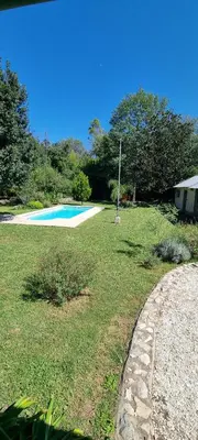 a yard with a swimming pool and a grass field at Casa de campo EL LULI in La Bolsa