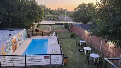 an overhead view of a swimming pool with tables and chairs at Complejo NONA RITA in Villa Cura Brochero