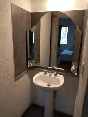a bathroom with a sink and a mirror at Casa con piscina en entorno muy verde in Villa Anizacate