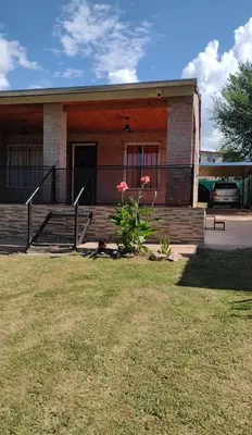 a small house with a porch and a flower at Casa REFUGIO PUNILLA in Cordoba