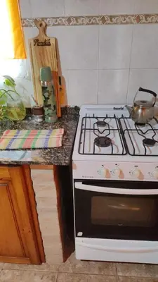 a kitchen with a stove and a counter top at Casa REFUGIO PUNILLA in Cordoba