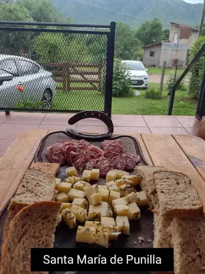 a tray of cheese and bread on a table at Casa REFUGIO PUNILLA in Cordoba