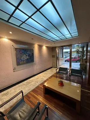 a living room with a skylight and a table and chairs at Departamento alquiler temporal 6 D INVERHOME INMOBILIARIA in Cordoba