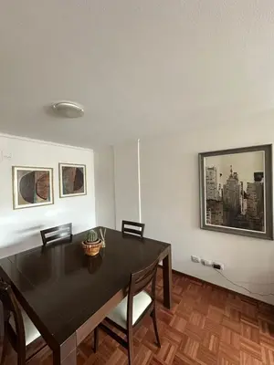 a dining room with a black table and chairs at Departamento alquiler temporal 6 D INVERHOME INMOBILIARIA in Cordoba