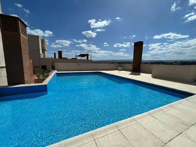 a large blue swimming pool on top of a building at Departamento 2 dormitorios excelente ubicacion in Villa Carlos Paz