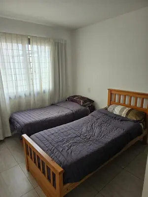 a bedroom with two beds and a window at Departamento 2 dormitorios excelente ubicacion in Villa Carlos Paz