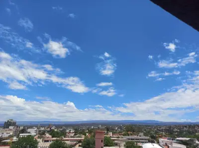 a blue sky with clouds over a city at Departamento 2 dormitorios excelente ubicacion in Villa Carlos Paz