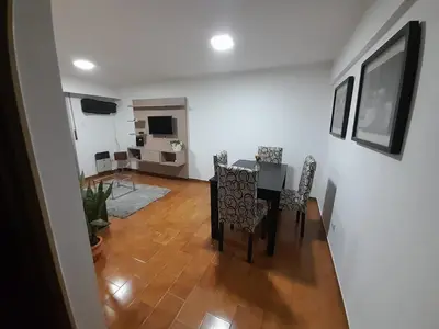 a dining room with a table and chairs and a living room at Osveli in Cordoba