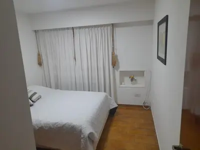 a bedroom with a white bed and a window at Osveli in Cordoba