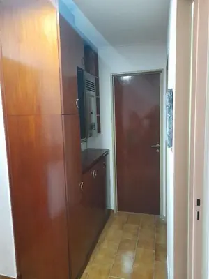 a hallway with a large wooden cabinet and a door at Osveli in Cordoba