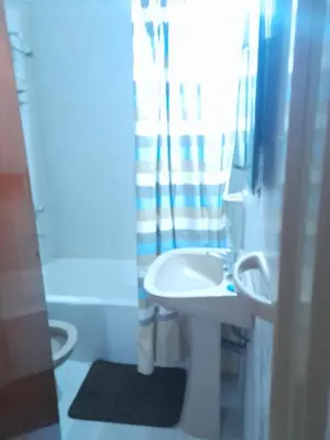 a bathroom with a white sink and a shower at Osveli in Cordoba