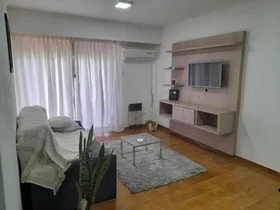 a living room with a couch and a flat screen tv at Osveli in Cordoba
