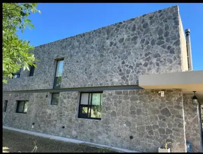a large stone building with windows on the side of it at Casa en Campo de GOLF in Los Molinos