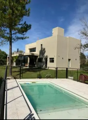 a swimming pool in front of a house at Casa en Campo de GOLF in Los Molinos