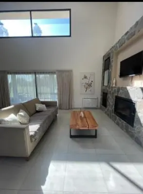 a living room with a couch and a fireplace at Casa en Campo de GOLF in Los Molinos