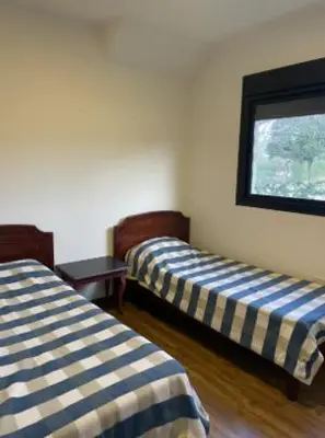 a room with two beds and a window at Casa en Campo de GOLF in Los Molinos