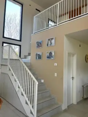 a staircase in a house with pictures on the wall at Casa en Campo de GOLF in Los Molinos