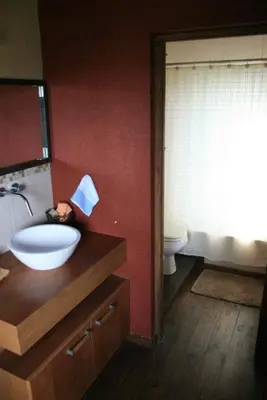 a bathroom with a sink and a toilet at Cabaña Espejo de Luna in La Estancia