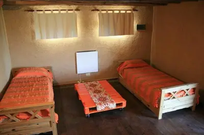 a room with two beds and a tv in it at Cabaña Espejo de Luna in La Estancia