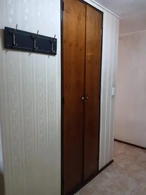 a wooden door in a room next to a wall at Adrimar Cordoba Centro in Cordoba