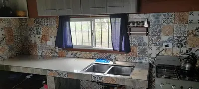 a kitchen with a sink and a window at Cabaña LA LUGARDA in Cuesta Blanca