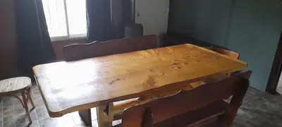 a wooden table and chairs in a room with a window at Cabaña LA LUGARDA in Cuesta Blanca