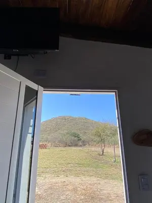 a window in a room with a view of a field at Cabañas Los Mellis in Barrio Parque El Corcovado