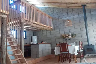 a kitchen with a wooden staircase in a room at Hermosa casa para parejas in Los Reartes