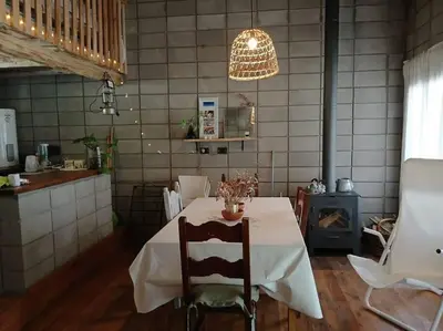 a dining room with a table with a white table cloth at Hermosa casa para parejas in Los Reartes