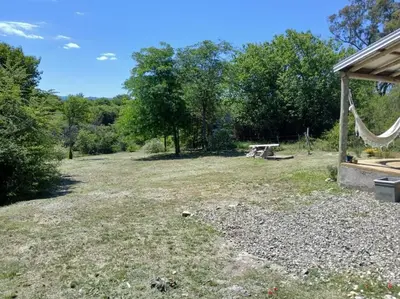 a large yard with a picnic table and trees at Hermosa casa para parejas in Los Reartes