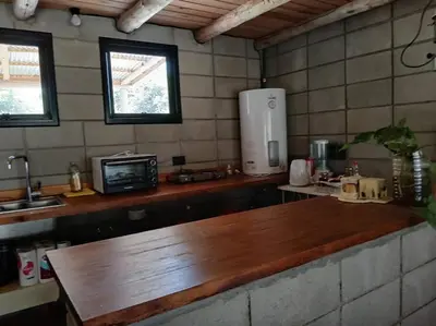a kitchen with a wooden counter top in a room at Hermosa casa para parejas in Los Reartes