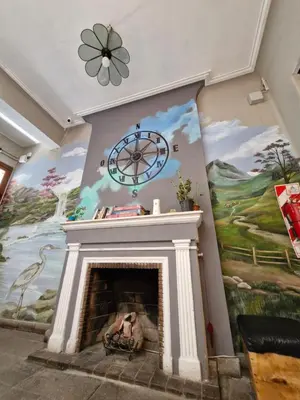 a living room with a fireplace with a painting at WHY NOT NUEVA CORDOBA in Cordoba