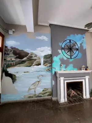 a wall with a painting of a river and a bird at WHY NOT NUEVA CORDOBA in Cordoba