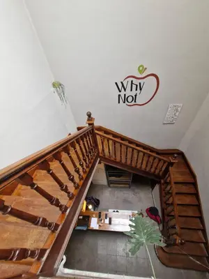 a staircase in a room with a sign on the wall at WHY NOT NUEVA CORDOBA in Cordoba