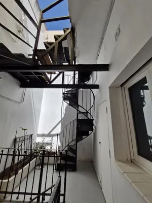an empty room with a spiral staircase in a building at WHY NOT NUEVA CORDOBA in Cordoba