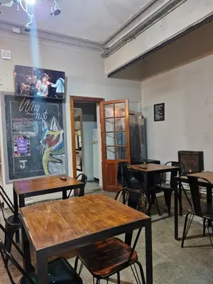 a dining room with tables and chairs and a chalkboard at WHY NOT NUEVA CORDOBA in Cordoba