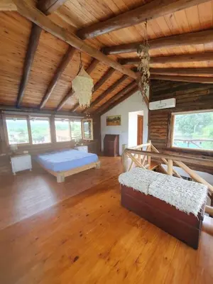 a large room with a bed and a wooden ceiling at La Traviata in Mina Clavero