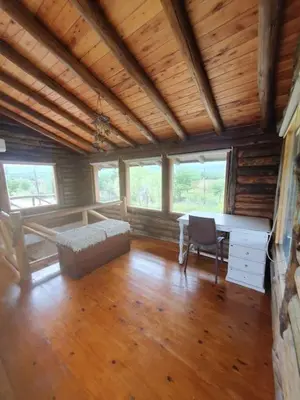 a room with a bed and a desk in a cabin at La Traviata in Mina Clavero