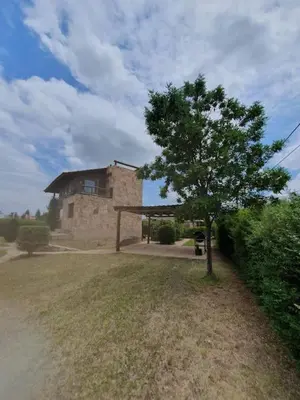 a tree in front of a house with a building at La Traviata in Mina Clavero