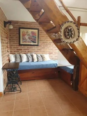 a bed in a room with a brick wall at La Traviata in Mina Clavero